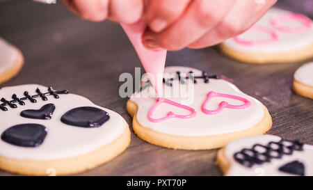 Schritt für Schritt. Dekorieren Sugar Skull Cookies mit anderen Farbe royal Vereisung. Stockfoto
