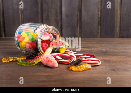 Mix bunte Bonbons im Glas in Holz- Hintergrund mit Kopie Raum, selektiven Fokus Stockfoto