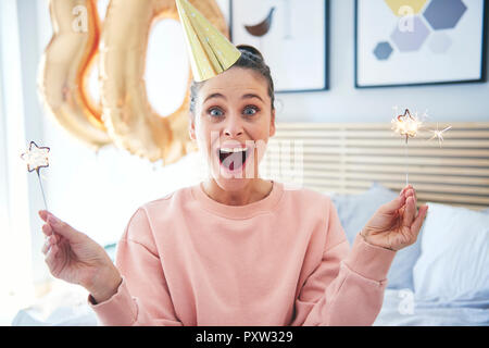 Fröhliche Frau bei ihren Geburtstag mit Wunderkerzen Stockfoto