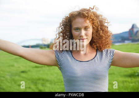 Portrait von lächelnden jungen Frau auf einer Wiese im Sommer Stockfoto
