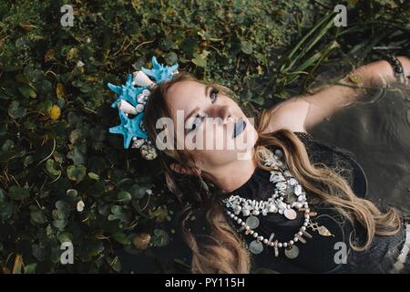 Porträt einer Boho liegende Frau im See, Russland Stockfoto