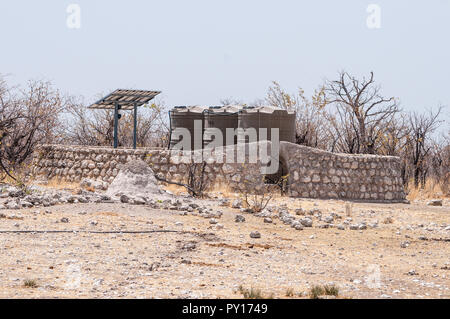 Wassertanks von Sonnenkollektoren für die künstlichen Wasserlöcher, Etosha National Park, Namibia Stockfoto