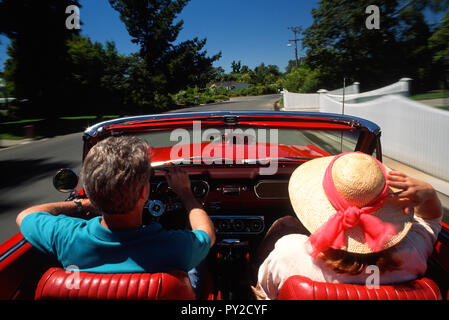 Paar mittleren Alters genießen eine Fahrt in einem Jahrgang 1966 Mustang Cabrio, USA Stockfoto