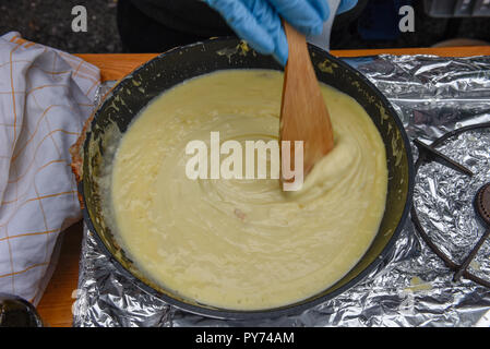 Zubereitung der traditionellen geschmolzenem Käse in einem Topf auf die Schweiz Stockfoto