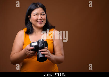 Schöne Übergewicht asiatische Frau Fotograf Denken und Planen Stockfoto