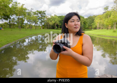 Schöne Übergewicht asiatische Frau Fotograf im Park Stockfoto