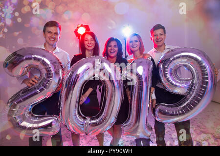 Party, Urlaub und Personen Konzept - Gruppe von Freunden feiern das neue Jahr Holding Big2019 Symbol Stockfoto