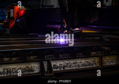 Arbeiter Schneiden von Stahl Rohr mit Metall Taschenlampe und Straßenrand Zaun installieren. Schweißer, Handwerker, Errichtung technische Stahl Industrie Stahl Schweißer in der Factory Stockfoto