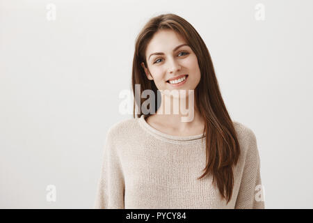 Gerne helfen. Portrait von höflich gut aussehende Office Assistenten stehen in warmen Pullover und breit grinsend, helfen wollen oder Kaffee an Kunden Neigekopf bieten, hören, um Stockfoto