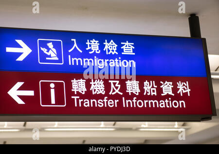 Ein Schild ist in Hong Kong Flughafen, Richtung der Position der Einwanderung und Transfer Flüge gesehen. Stockfoto