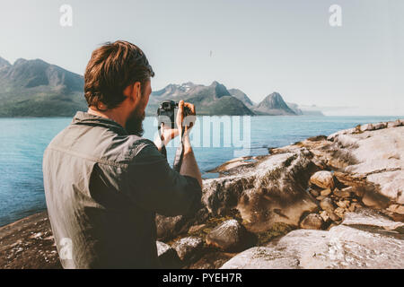 Mann reisen Fotograf Blogger mit Kamera, Foto von Bergen und Meer Landschaft reisen Freiberufler lifestyle hobby Konzept Abenteuer Sommer voy Stockfoto
