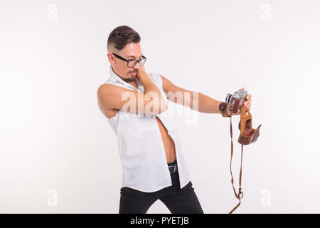 Personen, Foto und Stil Konzept - glückliche junge Mann unter selfie mit alten Foto Kamera auf weißem Hintergrund Stockfoto