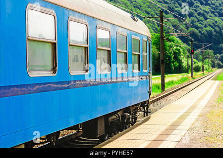 Blaue Bahn Wagen wartet an der Plattform für die Fahrgäste. Schienenverkehr in der Tschechischen Republik. Leere Plattformen auf regionaler Station. Einen sonnigen Tag auf. Stockfoto