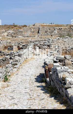 Enge gepflasterte Straße schlängelt sich durch das Wohngebiet im westlichen Teil der antiken Stadt Thera, Santorini, Griechenland. Aus dem Stockfoto