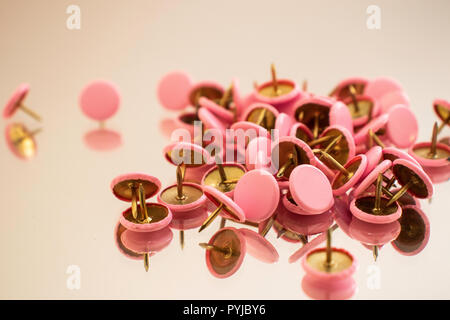 Rosa Stifte verstreut auf einer gespiegelten Oberfläche Stockfoto