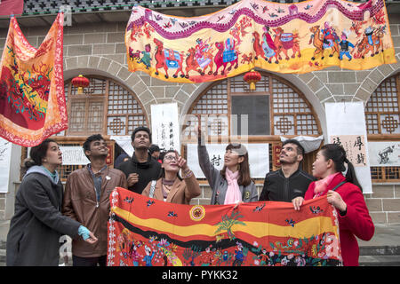 (181029) - Yan'an, Oktober 29, 2018 (Xinhua) - Ausländische Studierende und Volkskünstler Austausch Malerei Fähigkeiten in Gaoqiao Township in Ansai Bezirk, Yan'an, Provinz Shaanxi im Nordwesten Chinas, Okt. 20, 2018. Ansai Bezirk, im nördlichen Teil der Provinz Shaanxi auf dem Löß-Plateau, ist bekannt für seine einzigartige Volkskunst wie Ansai Taille Drum Dance bekannt, Papier-cut, Volkslieder, volkstümliche Malerei und Oper. In den letzten Jahren, Ansai hat sich bemüht, den kulturellen Tourismus durch die Integration von Tourismus mit diesen einzigartigen Volkskunst, um der Armut zu fördern. Nach einer Schulung, können Leute suppleme Stockfoto