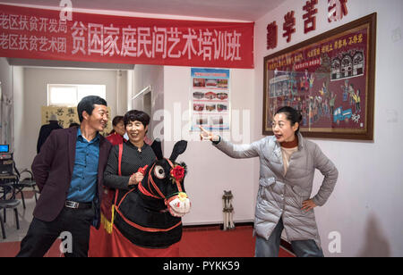 (181029) - Yan'an, Oktober 29, 2018 (Xinhua) - Li Chenghong (Lst. L) und Shen Aizheng lernen von volkskünstler Yan Taotao (1. R) bei einem volkskunst Ausbildung Klasse von Chengbei Gemeinschaft in Ansai Bezirk, Yan'an, Provinz Shaanxi im Nordwesten Chinas, Okt. 19, 2018. Ansai Bezirk, im nördlichen Teil der Provinz Shaanxi auf dem Löß-Plateau, ist bekannt für seine einzigartige Volkskunst wie Ansai Taille Drum Dance bekannt, Papier-cut, Volkslieder, volkstümliche Malerei und Oper. In den letzten Jahren, Ansai hat Anstrengungen unternommen, um den Kulturtourismus zu fördern durch die Integration von Tourismus mit diesen einzigartigen Volkskunst, damit eradicat Stockfoto