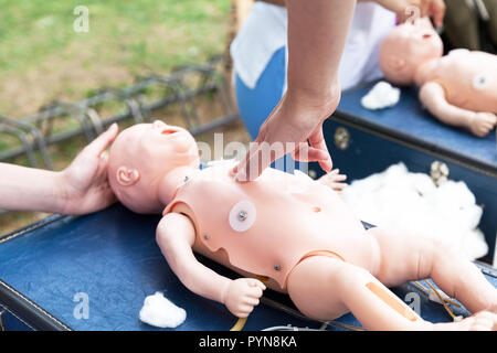 Sanitäter der Thoraxkompressionen Praxis mit zwei Fingern, Auf einem Säugling dummy während der Schulung in erster Hilfe. Stockfoto