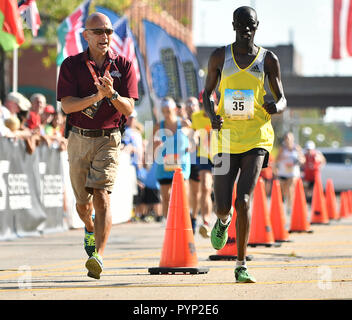 Moline, Iowa, USA. 24 Sep, 2017. Langjährige Race Director Joe Moreno läuft neben Michael cheptoo an der Ziellinie der 2017 Quad Cities Marathon. Das 21 QC Marathon Schritte aus um 7 Uhr Sonntag. Credit: Meg Mclaughlin/Viererkabel - Zeiten/ZUMA Draht/Alamy leben Nachrichten Stockfoto