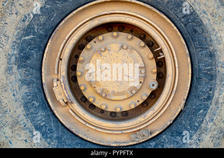 Große Schlamm bedeckt Reifen von gelb Baufahrzeug Stockfoto