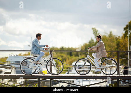Freundliche paar Fahrrad auf schmalen hölzernen Pier Stockfoto