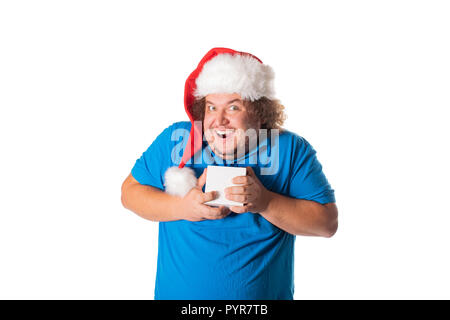Funny fat man in Santa Hut mit Geschenken. Weihnachten und Geschenke. Emotionen Stockfoto