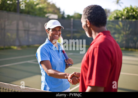 Der Mann und die Frau die Hände schütteln, nachdem ein Tennis Spiel. Stockfoto