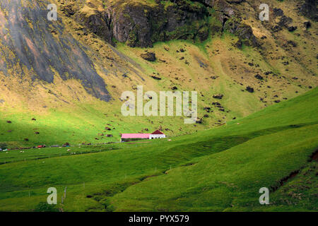 Ein Bauernhaus und der Kirche in der fernen Berge und Landschaft von South East Island. Stockfoto