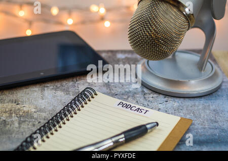 Podcast Ideen Konzept mit Mikrofon, Notepad, Tablet an Bord Stockfoto