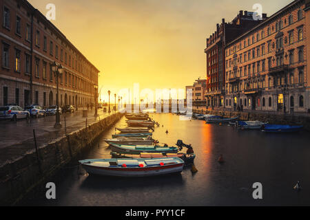 Triest, Italien. Grand Canal am Abend. Sonnenuntergang Himmel mit Booten und historischen Gebäuden Stockfoto