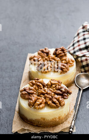 Zwei mini Nussbaum Käsekuchen auf schwarzen Stein Hintergrund Stockfoto