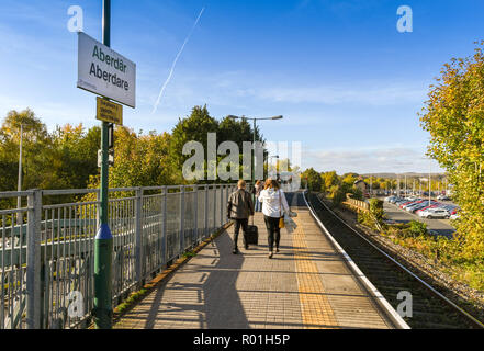 ABERDARE, WALES - Oktober 2018: Pendler wallking entlang der einzigen Plattform auf dem Bahnhof in Aberdare. Stockfoto