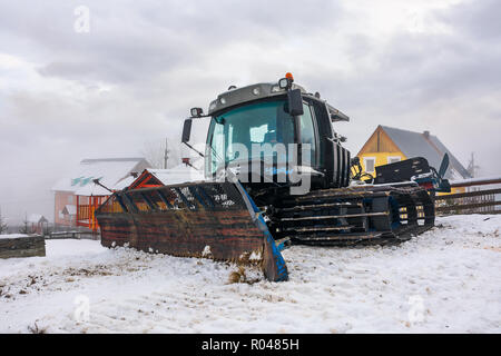 Pylypets, Ukraine - Dec 21, 2016: pistenfahrzeug im Resort Village geparkt. riesige Maschinen ohne eine Arbeit an einem trüben Wintertag Stockfoto