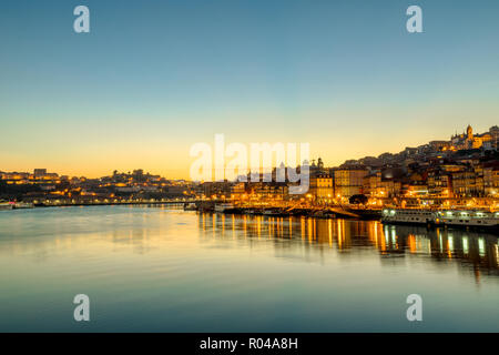 Oporto Skyline am Fluss Douro bei Dämmerung wider. Porto ist die zweite größte Stadt Portugals. Malerische Stadt abend Stadtbild. Stockfoto