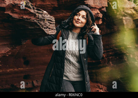 Frau stehend auf Rocky Mountain entfernt. Weibliche im Winter Verschleiß auf. Stockfoto