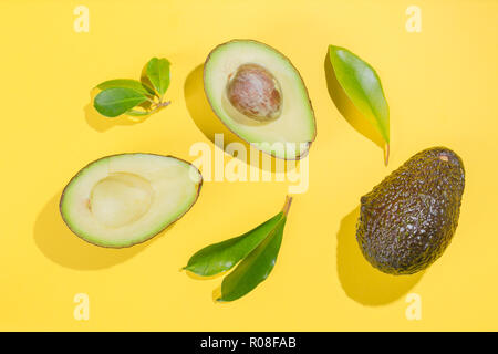Scheiben Avocado auf weißem Hintergrund. Ganze und halbe mit Blättern. Design Element für Etikett, Ansicht von oben Stockfoto
