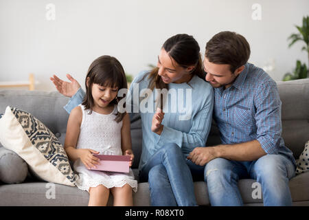 Eltern gratulieren liebevolle Tochter sitzen zusammen auf der Couch Stockfoto