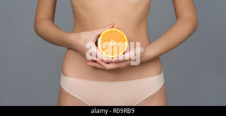 Verschiedene Ausdruck von jungen Mädchen mit frischen orange Frucht auf neutralem Hintergrund Stockfoto