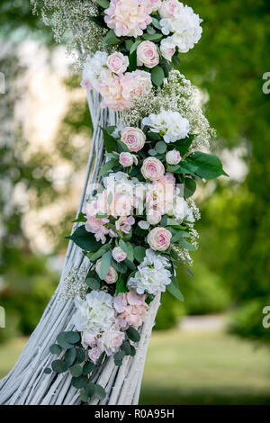 Außenpool im Sommer Hochzeit Dekoration. Dekoration von weissen Rosen, Hortensien und Gypsophila auf dem Bogen für die Trauung. Vertikale Ansicht. Stockfoto