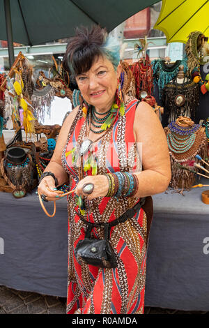 Stellen Portrait eines älteren israelischen Frau mit blauen Haaren, die Leder Schmuck auf dem Carmel-markt in Tel Aviv, Israel verkauft. Stockfoto