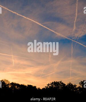 Kondensstreifen, auch Kondensstreifen oder Vapor Trail, Streamer von Cloud manchmal hinter einem Flugzeug fliegen in klaren kalten feuchten Luft beobachtet. Es bildet auf die Kondensation von Wasserdampf durch die Verbrennung von Kraftstoff im Flugzeug Motoren produziert. Wenn die relative Luftfeuchtigkeit hoch ist, die daraus resultierenden ice-crystal Plume kann mehrere Stunden dauern. Die Spur kann durch die Winde verzerrt werden, und manchmal es breitet sich nach außen eine Schicht von Zirruswolken zu bilden. Diese wurden im Süden von England in den frühen Morgenstunden fotografiert. Stockfoto