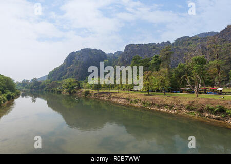 Nam Song Fluss und Kalkstein Karst Bergen nahe der Tham Chang (oder Jang oder Jung) Höhle in Vang Vieng, Laos, an einem sonnigen Tag. Stockfoto