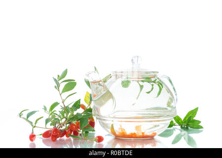 Heißen Tee von reifen roten Goji Beeren in eine Teekanne aus Glas Stockfoto