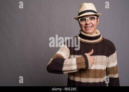 Stilvolle jungen asiatischen Teenager tragen warme Kleidung gegen gr Stockfoto