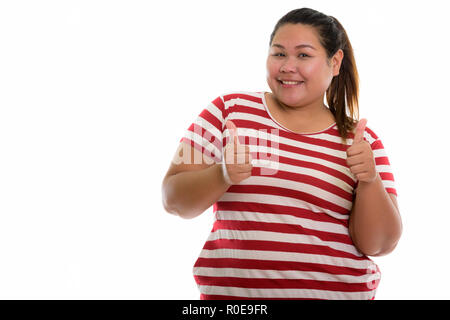 Studio shot der Jungen gerne Fett asiatische Frau lächelnd und geben. Stockfoto