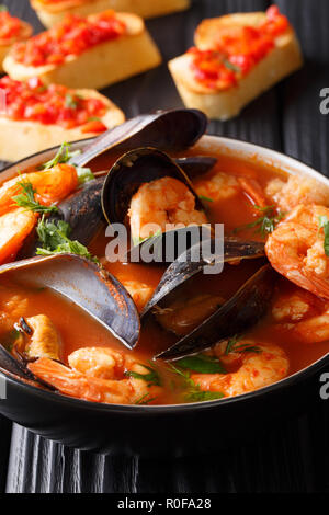 Traditionelle Marseille Fischsuppe bouillabaisse mit Garnelen, Fisch Filet und Muscheln closeup in einer Schüssel auf dem Tisch. Vertikale Stockfoto