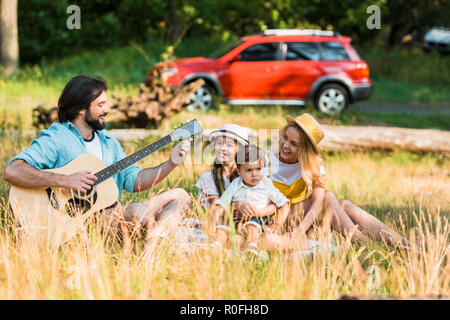 Gerne Vater Stimmen akustischer Gitarre im Picnic Stockfoto