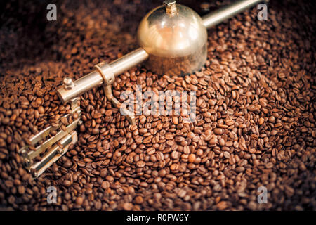 Kaffeeröster, frisch geröstete Kaffeebohnen Hintergrund Stockfoto