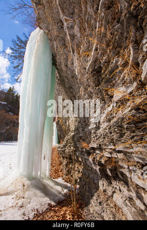 Gefrorenen Wasserfällen auf einer Klippe in Watkins Glen State Park, Watkins Glen, im Staat New York an einem sonnigen, aber kalten Wintertag. Stockfoto