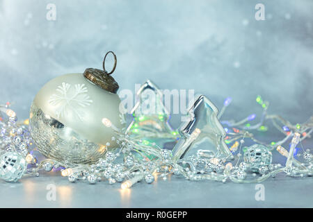 Christbaumschmuck, glas kugel und Tanne auf frostigen blauen Hintergrund mit leuchtenden Leds Stockfoto